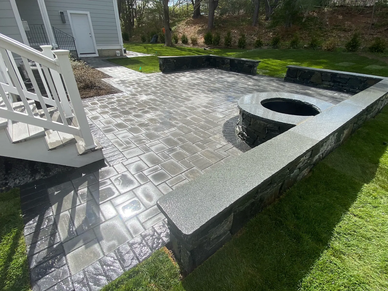 Granite-capped stone firepit on bluestone patio