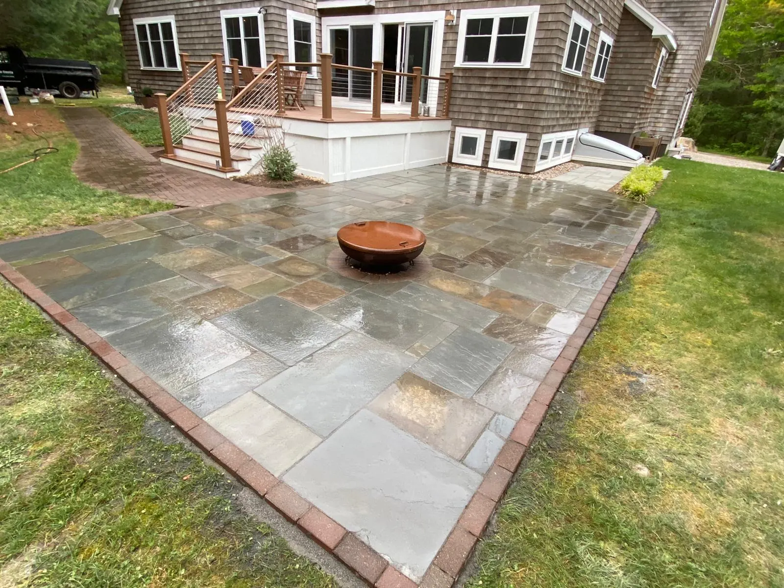Bluestone patio with carved stone bowl planter