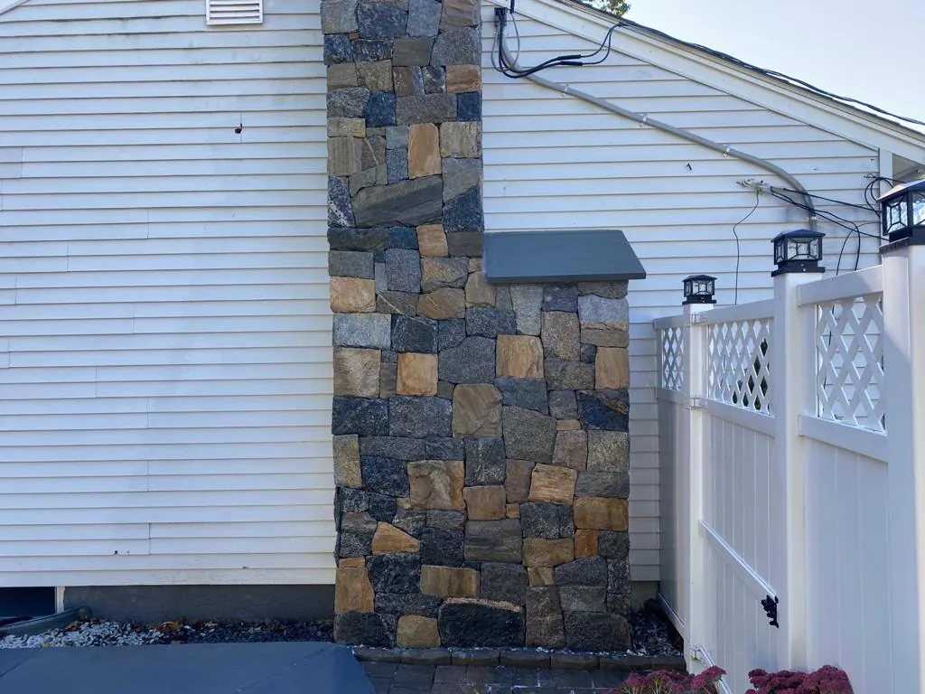 Stone veneer chimney and outdoor fireplace